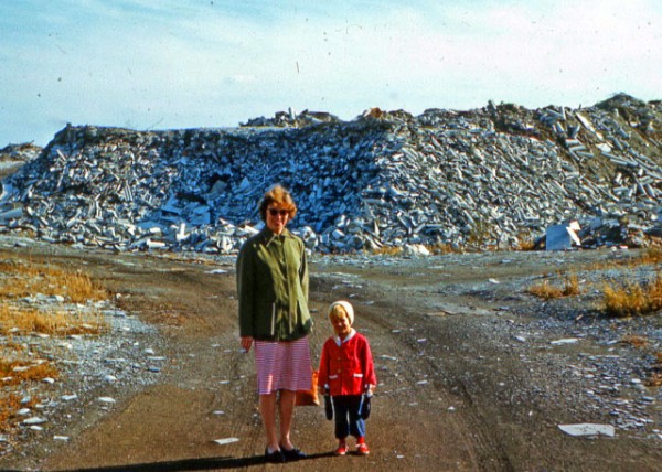 An unknown woman and child standing in front of the White Mountains of Ambler, Pennsylvania, ca. 1963C1964..JPG