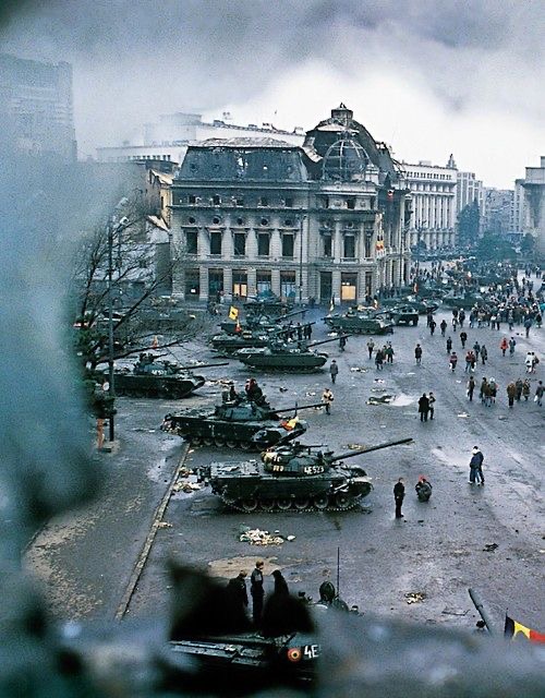Revolution_Square_of_Bucharest,_Romania,_during_the_1989_Revolution._Photo_taken_from_a_broken_window_of_the_Athénée_Palace_Hotel.jpg