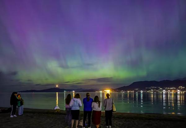 6People gather at Jericho Beach in Vancouver to see the lights on Friday.jpg