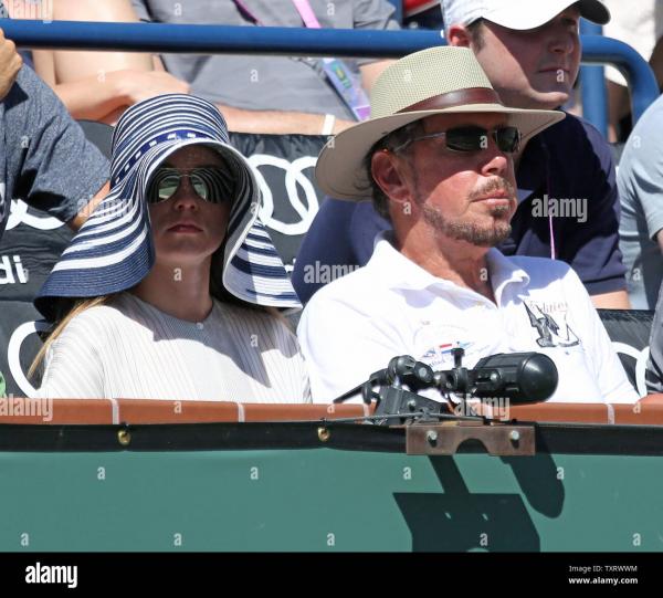 oracle-ceo-and-tournament-majority-owner-larry-ellison-r-and-his-girlfriend-nikita-kahn-watch-the-mens-semifinal-match-between-roger-federer-of-switzerland-and-milos-raonic-of-canada-at-the-bnp-paribas-open-in-indian-wells-california-on-mar.jpg