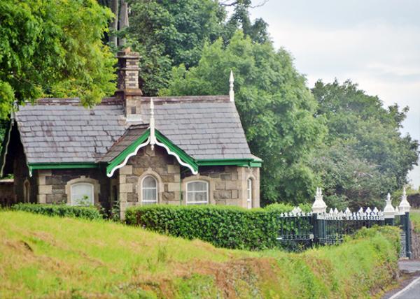 2016-07-11_Small Stone House, Built in a Gothic Architectural Style, w Wrought Iron Fence, Hills in the Background w Tall Trees0001.jpg
