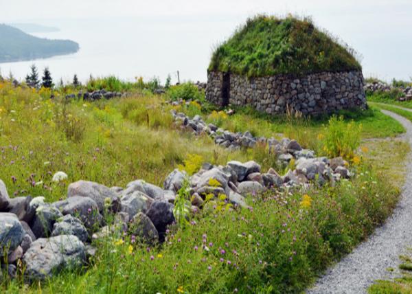 2023-08-17_Highlight Village Museum_Black House of Stone w Sod Roof against Shoreline of Bras d'Or Lake near Iona on Cape Breton Is0001.JPG