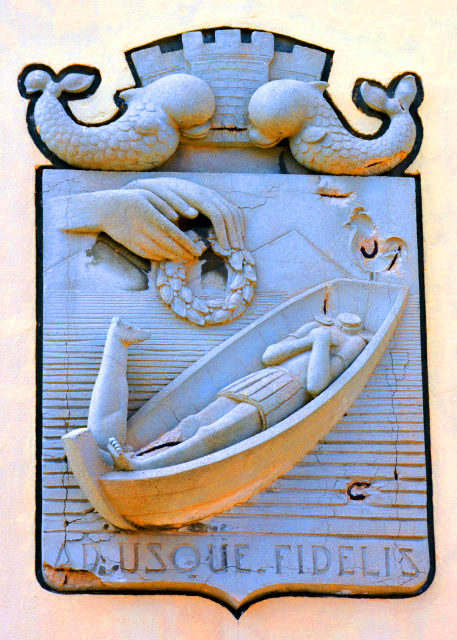 1770689948288601.jpg 2024-06-02_Town Emblem w Latin Inscription about Faithful Till the End w a Boat Containing Headless Body of the Martyr St Torpes_ Dog_ Rooster_ & Hands Holding Garland0001.JPG