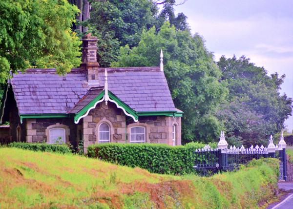 2016-07-11_Small Stone House, Built in a Gothic Architectural Style, w Wrought Iron Fence, Hills in the Background w Tall Trees0001.jpg