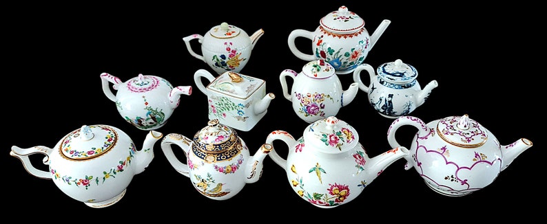 May include: A collection of ten miniature porcelain teapots with various floral and geometric designs. The teapots are white with colorful hand-painted details.