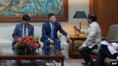 资料照片：2026年7月21日菲律宾总统小费迪南德·马科斯(右)召见中国驻菲律宾大使井泉(中)就7月20日中国海警与菲律宾海军在有争议的南中国海水域发生冲突，导致两名菲律宾士兵受伤一事进行会谈。